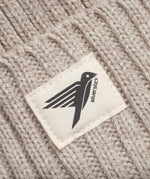A close up of the label on the Silverstick Moffat Merino Wool Beanie in the Oat colourway. Silverstick are proudly made in the UK and available at Babipur. 