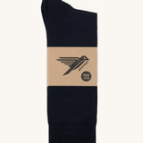 A pair of black GOTS-Certified organic cotton everyday socks by Silverstick in recyclable paper packaging, made in Britain.