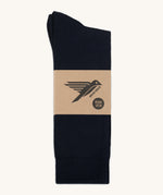 A pair of black GOTS-Certified organic cotton everyday socks by Silverstick in recyclable paper packaging, made in Britain.