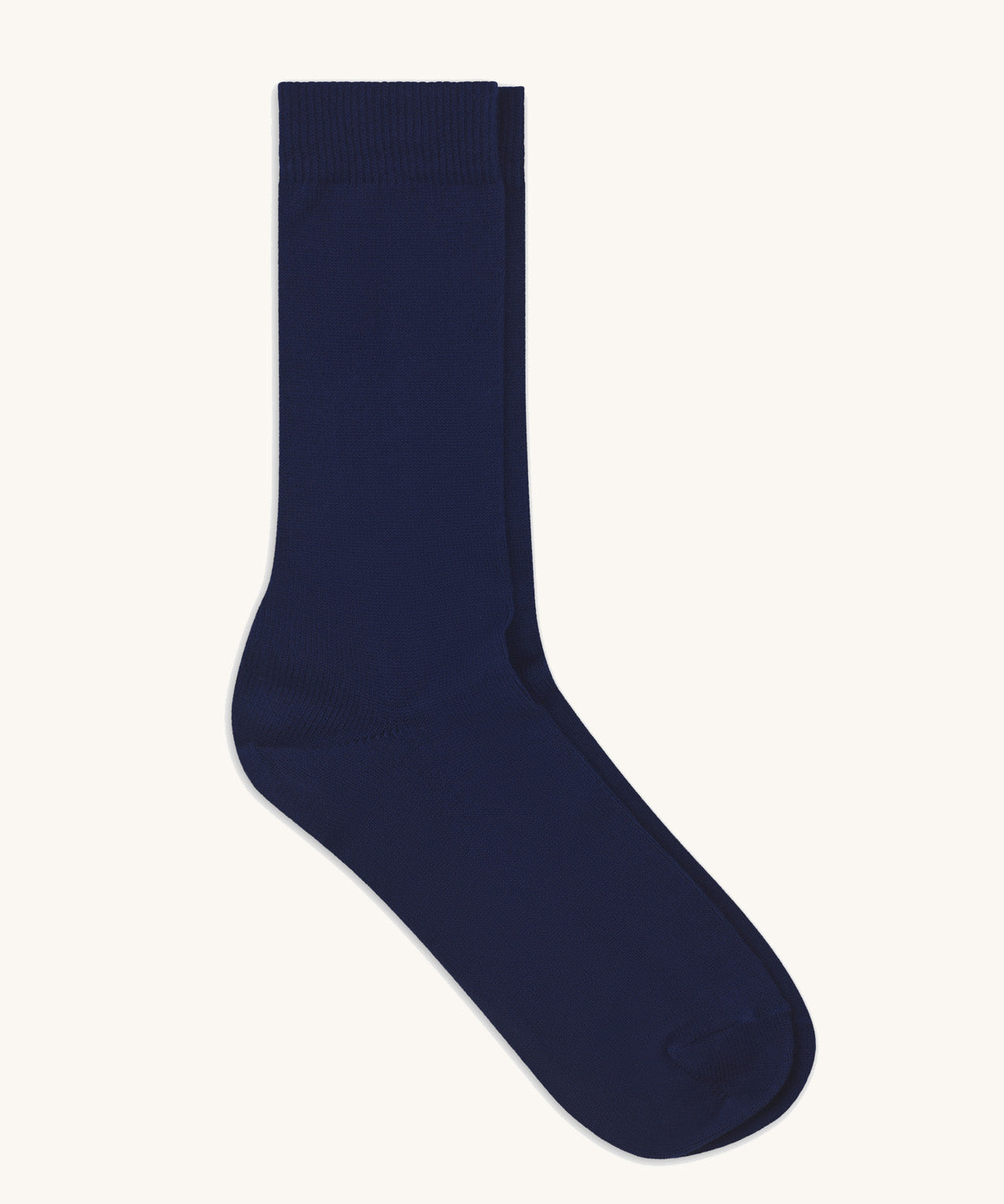 A pair of solid navy blue socks by Silverstick, made from GOTS Certified organic cotton grown in India and knitted in the UK. 