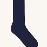 A pair of solid navy blue socks by Silverstick, made from GOTS Certified organic cotton grown in India and knitted in the UK. 