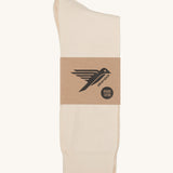 A pair of white GOTS-Certified organic cotton everyday socks by Silverstick in recyclable paper packaging, made in Britain.