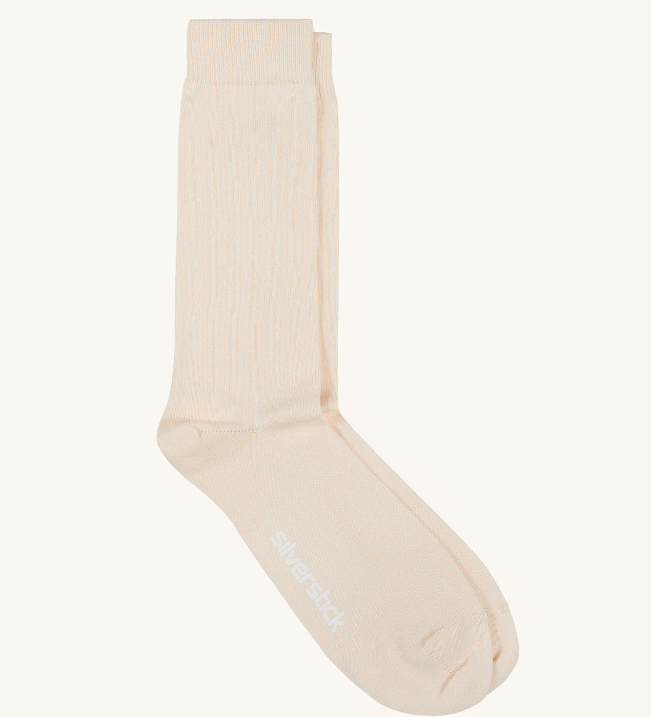 A pair of solid white socks by Silverstick, made from GOTS Certified organic cotton grown in India and knitted in the UK. 