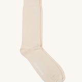 A pair of solid white socks by Silverstick, made from GOTS Certified organic cotton grown in India and knitted in the UK. 