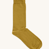 A pair of solid yellow socks by Silverstick, made from GOTS Certified organic cotton grown in India and knitted in the UK. 