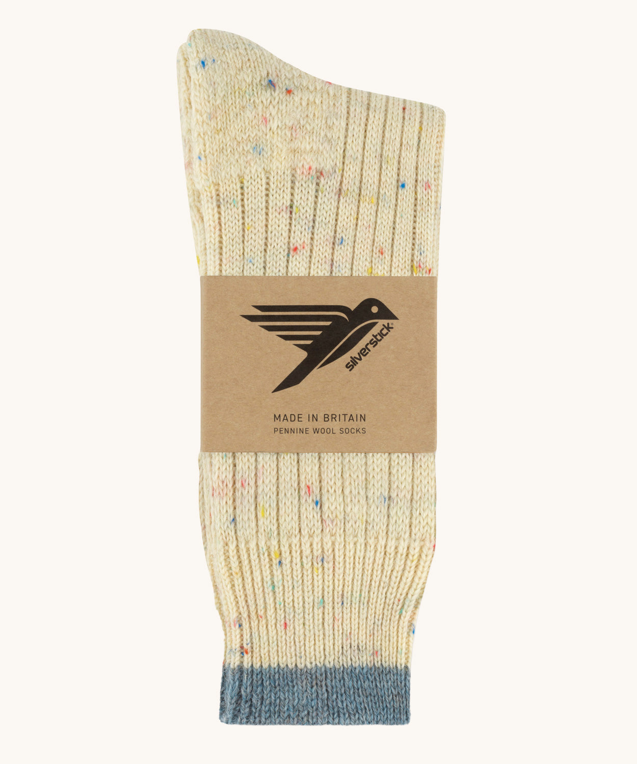 The Silverstick Pennine Wool Socks in the rainbow nepp colourway shown folded over and placed in their cardboard packaging sleeve. 