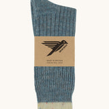 The Silverstick Pennine Wool Socks in the summer storm colourway shown folded over and placed in their cardboard packaging sleeve. 