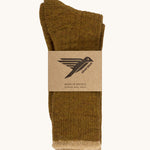 The Silverstick Pennine Wool Socks in the Harvest colourway shown folded over and placed in their cardboard packaging sleeve. 