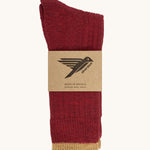 The Silverstick Pennine Wool Socks in Red shown folded over and placed in their cardboard packaging sleeve. 