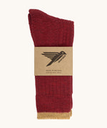 The Silverstick Pennine Wool Socks in Red shown folded over and placed in their cardboard packaging sleeve. 