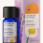 Sleep Well pure essential oil blend in a blue glass bottle in front of a decorative pink cardboard box.