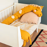  long giraffe cushion in mustard yellow with cream spots