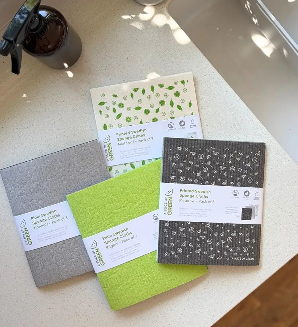 A Slice of Green Swedish sponge cloths in different colours, made from natural materials and recycled cotton, used in an eco-friendly kitchen.