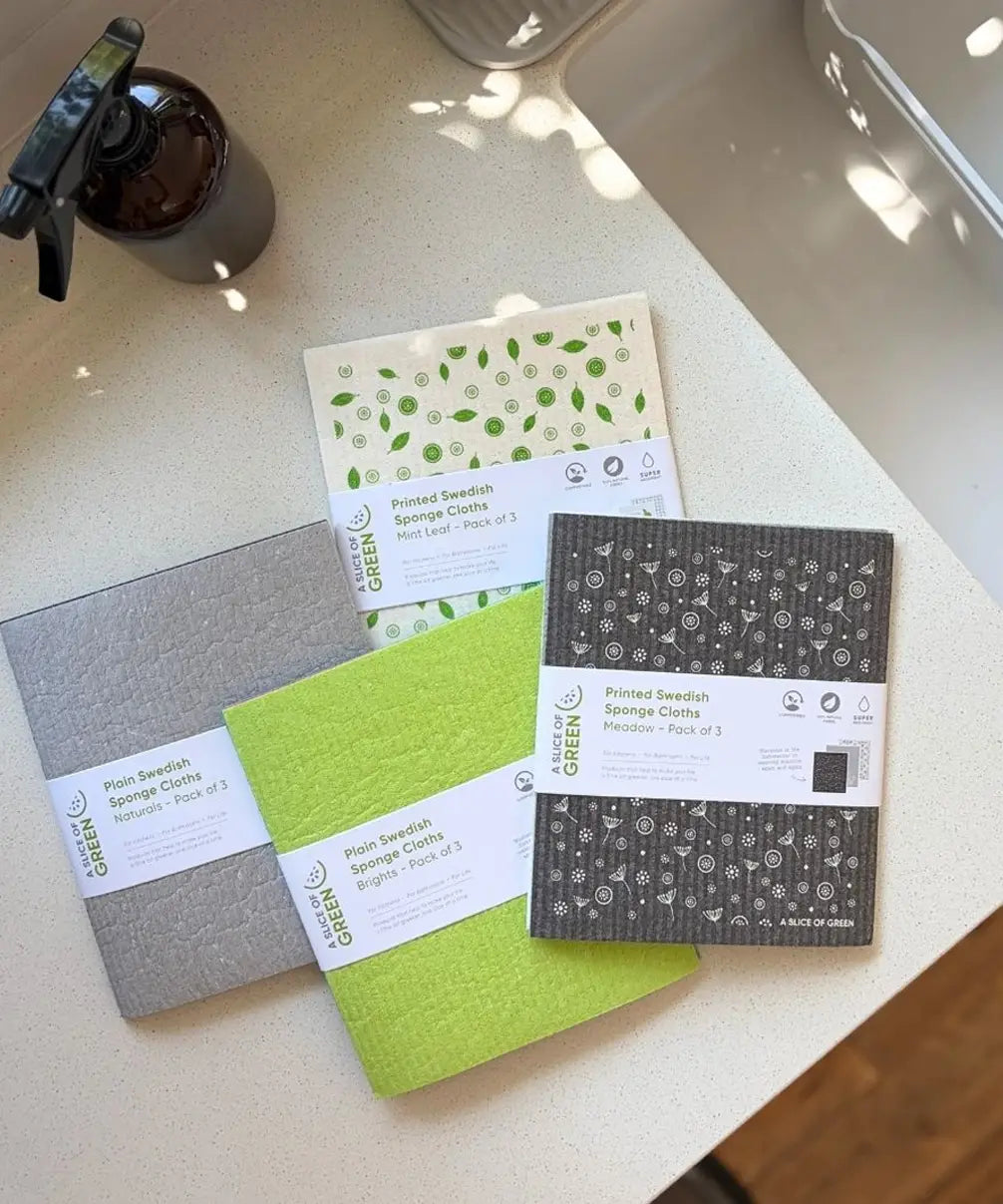 A Slice of Green Swedish sponge cloths in different colours, made from natural materials and recycled cotton, used in an eco-friendly kitchen.