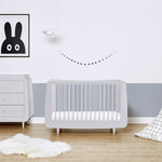 A haze grey SnuzKot pictured in a nursery