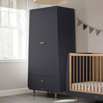 A slate SnuzKot Wardrobe pictured in a nursery placed next to a matching Snuzkot cot bed 