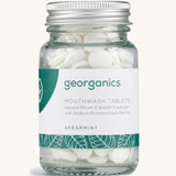 A Jar of the spearmint Georganics mouthwash tablets on a cream background