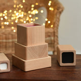 Blocks from the Bajo Square Pyramid Sensory Wooden Stacking Toy placed on a small wooden table. The set contains 5 wooden square and rectangular shaped blocks with a different coloured bases. Each blocks make a different sound when shaken. These heirloom quality toys by Bajo are part of a wide range of wooden toys available here at Babipur. 