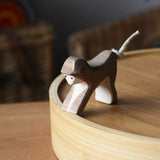 Ostheimer monkey wooden toy figure placed on a bamboo tray. 