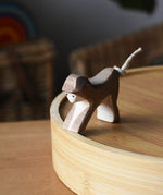 Ostheimer monkey wooden toy figure placed on a bamboo tray. 
