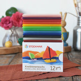 Stockmar Modelling Beeswax Clay 12 Colour Sheets stacked up on the cardboard packaging. 