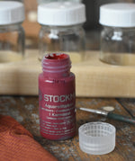 Stockmar 20ml concentrated watercolour paint in carmine red with the lid taken off. 