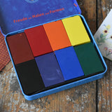 Stockmar 8 wax blocks in standard colours in a storage tin. Brown, red, orange, yellow, black, purple, blue and green.