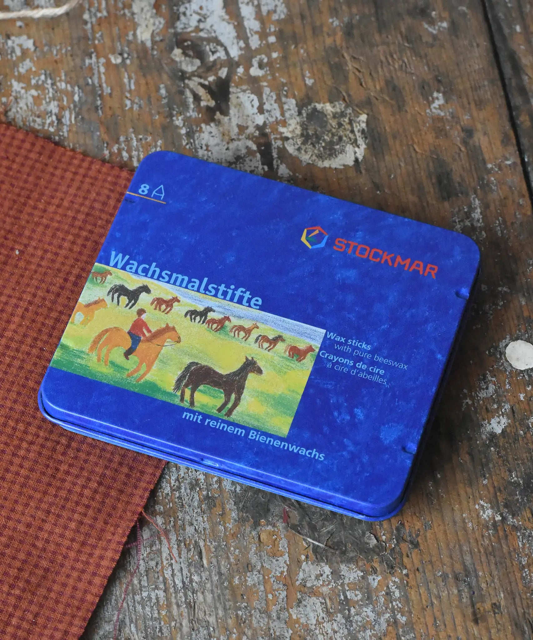 Stockmar 8  colour assortment wax crayons in a blue metal storage tin. 