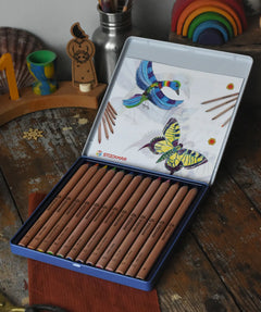 Stockmar 12 triangular shaped colouring pencils in a metal storage tin. 