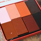 Close up of Stockmar colours of the world skin tone colour wax blocks crayons in a metal storage tin. 