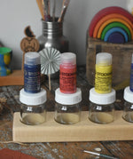 Stockmar 20ml concentrated watercolour paint pots placed on top of the glass jars.