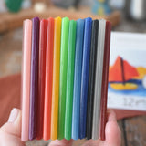 Stockmar Modelling Beeswax Clay 12 Colour Sheets in an adult's hand. 