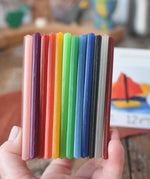 Stockmar Modelling Beeswax Clay 12 Colour Sheets in an adult's hand. 