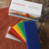 Stockmar modelling beeswax in a pack of 6 Sheets. White, brown, red, yellow green and blue sheets shown outside the cardboard box.