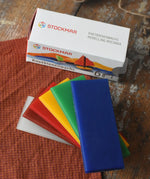 Stockmar modelling beeswax in a pack of 6 Sheets. White, brown, red, yellow green and blue sheets shown outside the cardboard box.