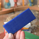 Blue sheet of Stockmar modelling beeswax in an adult's hand.