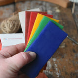 6 sheets of Stockmar modelling material beeswax in an adult's hand.