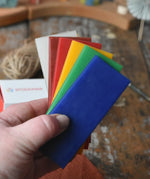 6 sheets of Stockmar modelling material beeswax in an adult's hand.