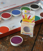 Stockmar Opaque Watercolour Replacements in red violet purple with the 12 hole watercolour tin set in the back.