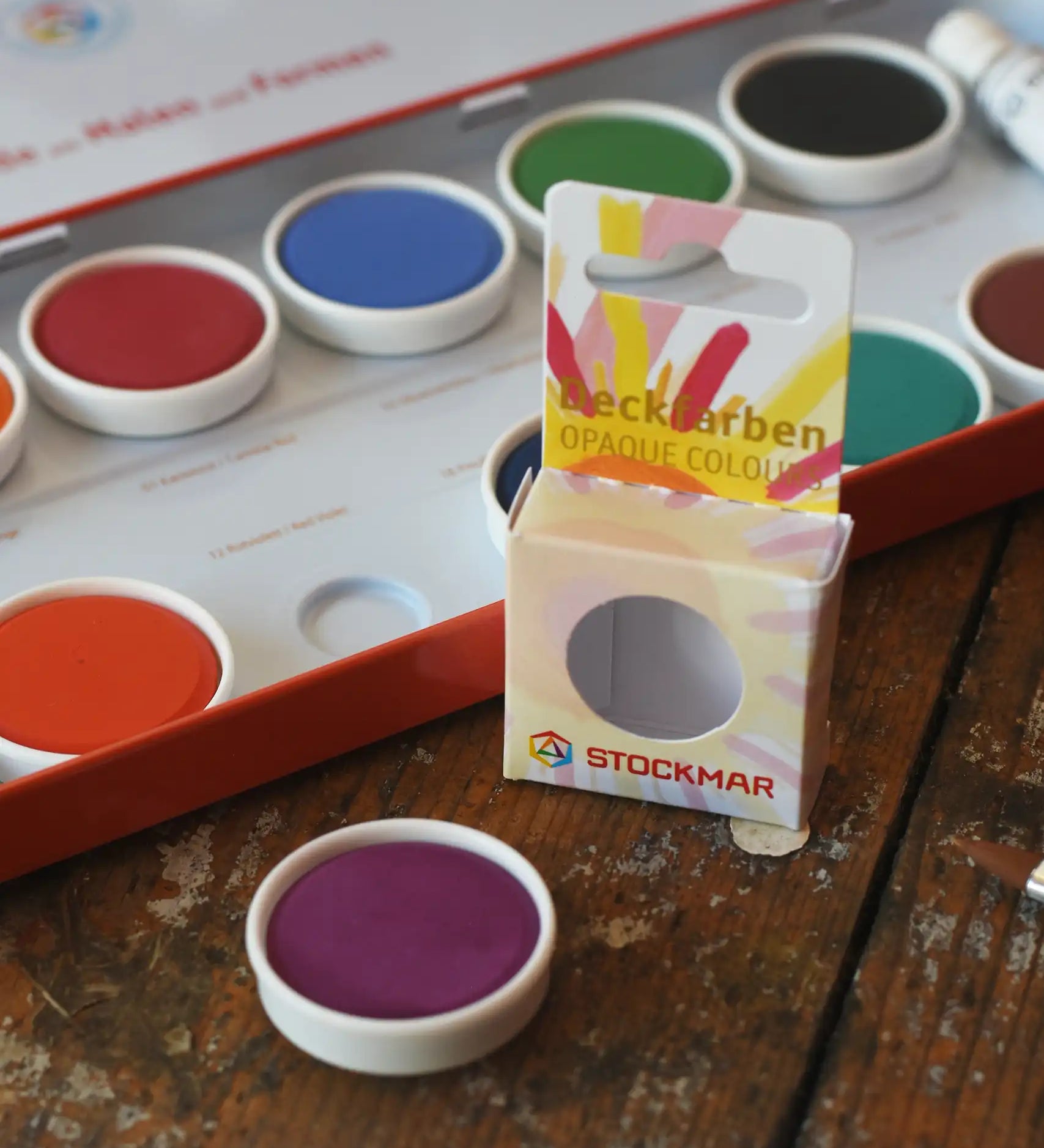 Stockmar Opaque Watercolour Replacements in red violet purple with the 12 hole watercolour tin set in the back.
