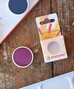 Stockmar Opaque Watercolour Replacements in red violet purple with the 12 hole watercolour tin set in the back.