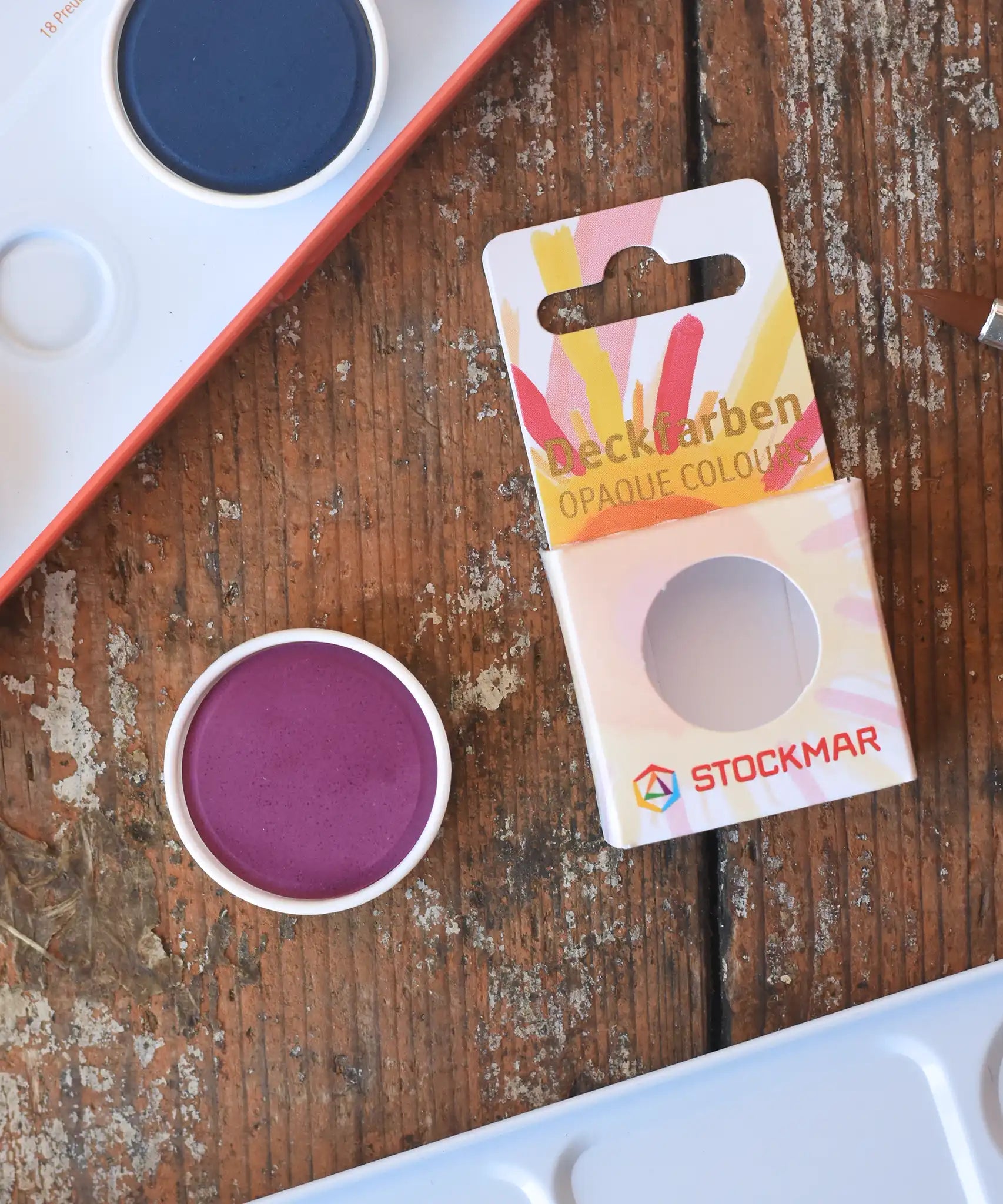 Stockmar Opaque Watercolour Replacements in red violet purple with the 12 hole watercolour tin set in the back.