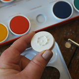 Bottom of the removable paint pans in the Stockmar Opaque Watercolour Paint Tin Set.