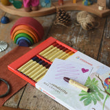 Stockmar 32 wax crayons stick set pack. Simple line and a heart drawn on a piece of paper placed on top of the box.