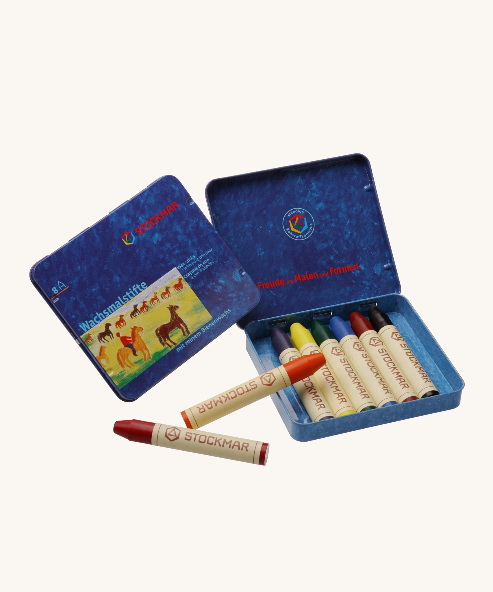 Stockmar 8 Standard Colour assortment Wax Crayons in a tin. Carmine red, orange, lemon yellow, green, blue violet, rust and black coloured wax crayon sticks with a wax scraper in a blue coloured metal tin storage box. 