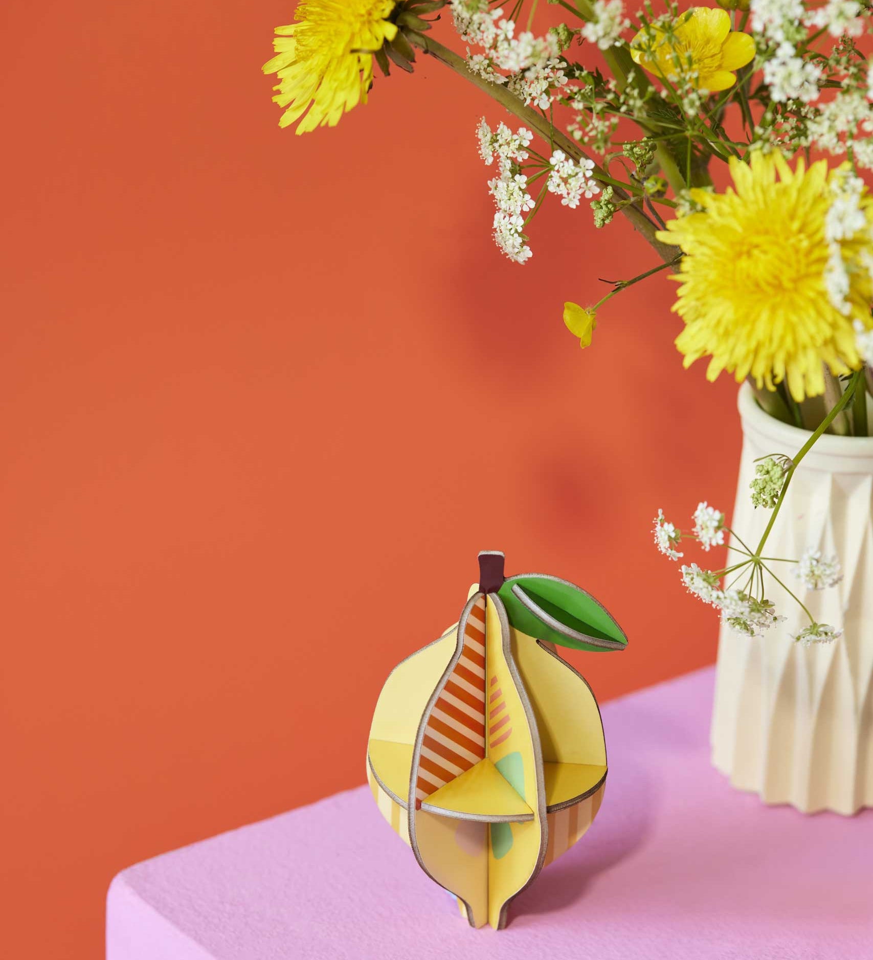 The Studio Roof 3D Pop Out Card Lemon placed on a sideboard next to flowers. This 3D pop out card DIY kit is part of Studio Roof's fruits  collection which is available at Babipur. 