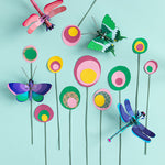 Studio Roof insects collection mounted on a pink panel of a colourful wall with a blue painted ladder