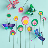 Studio Roof insects collection mounted on a pink panel of a colourful wall with a blue painted ladder