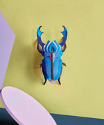 Studio Roof 3D cardboard azure stag beetle craft kit displayed on a wall 