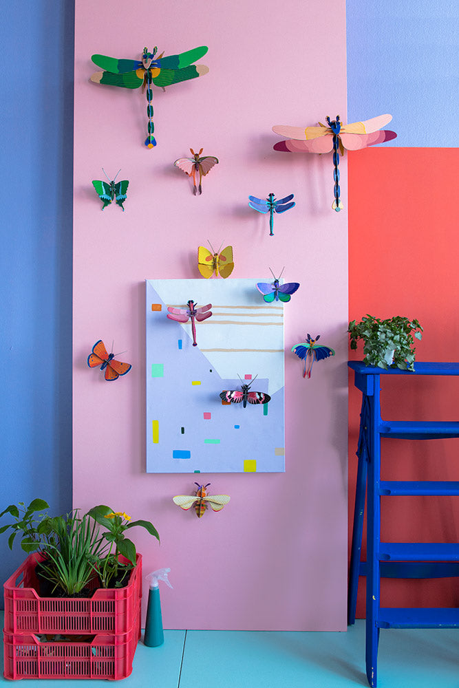mounted on a purple wall with a red chair